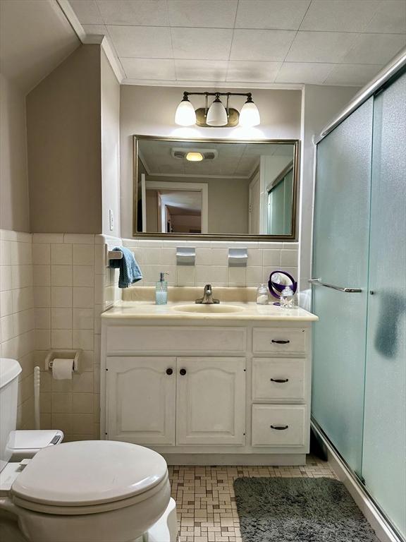 3 Centre St, Waltham, MA 02453 - full bath with toilet, vanity, a shower stall, and tile walls