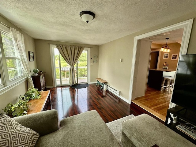 3 Centre St, Waltham, MA 02453 - living room featuring hardwood / wood-style floors, a textured ceiling, baseboards, a chandelier, and a baseboard heating unit