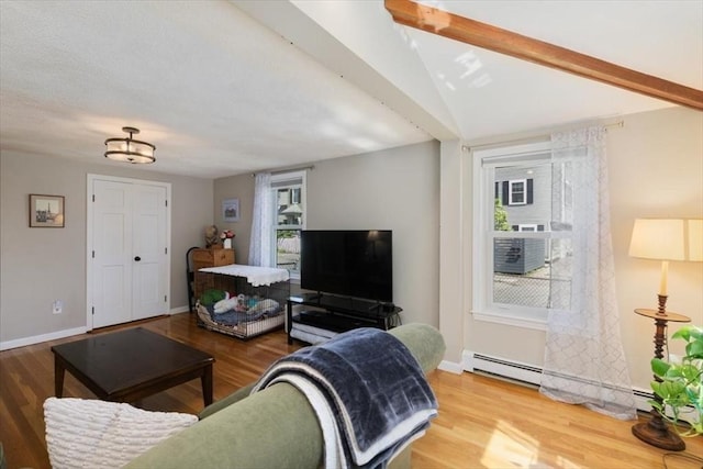 3 Centre St, Waltham, MA 02453 - living area with wood finished floors, baseboards, and a baseboard heating unit
