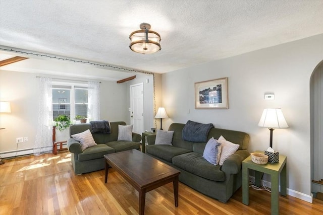 3 Centre St, Waltham, MA 02453 - living room with a textured ceiling, wood finished floors, baseboard heating, and baseboards
