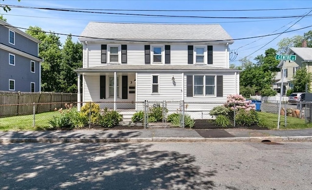 3 Centre St, Waltham, MA 02453 - view of front facade featuring covered porch and a fenced front yard