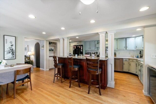 3 Centre St, Waltham, MA 02453 - kitchen featuring dishwasher, freestanding refrigerator, ornate columns, crown molding, and wine cooler
