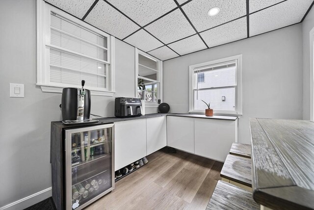 54 Forest St, Wilmington, MA 01887 - bar area with wine cooler, a paneled ceiling, and wood finished floors