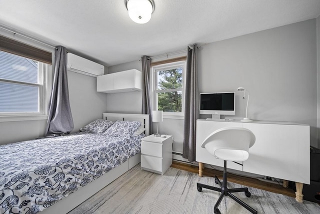 54 Forest St, Wilmington, MA 01887 - bedroom featuring light wood finished floors, a wall mounted AC, and an office area