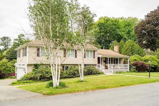 10 Ballard Ter, Lexington, MA 02420 - split level home featuring a porch, a chimney, a front lawn, and asphalt driveway