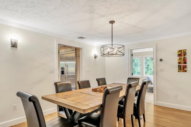 10 Ballard Ter, Lexington, MA 02420 - dining room featuring ornamental molding, a textured ceiling, a chandelier, light wood-style floors, and baseboards
