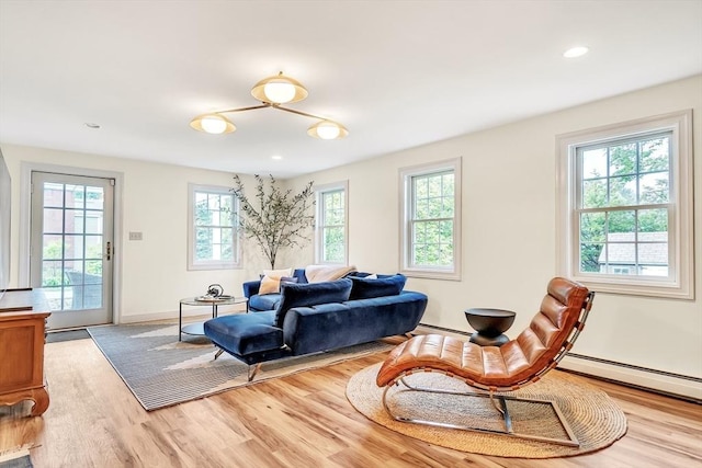 10 Ballard Ter, Lexington, MA 02420 - living area with wood finished floors, baseboards, baseboard heating, and recessed lighting