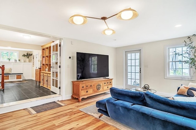 10 Ballard Ter, Lexington, MA 02420 - living area featuring wood finished floors, healthy amount of natural light, and baseboards