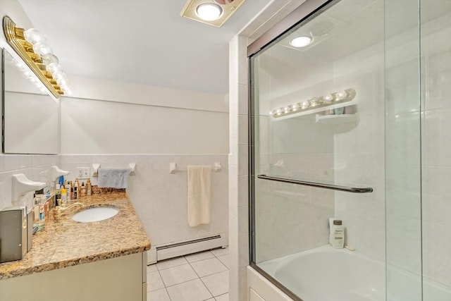 10 Ballard Ter, Lexington, MA 02420 - bathroom featuring baseboard heating, vanity, tile patterned floors, bathing tub / shower combination, and tile walls
