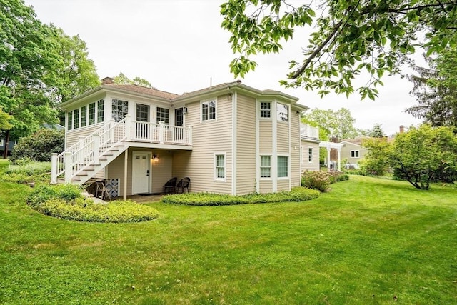 10 Ballard Ter, Lexington, MA 02420 - back of property featuring stairs, a chimney, a lawn, and a deck