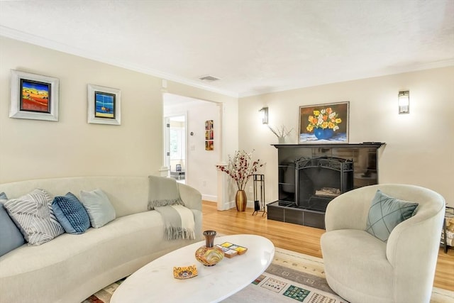 10 Ballard Ter, Lexington, MA 02420 - living area with wood finished floors, crown molding, a tiled fireplace, and baseboards