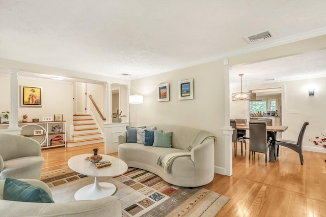 10 Ballard Ter, Lexington, MA 02420 - living room with stairs, crown molding, light wood-style floors, and baseboards