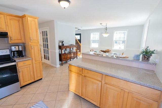 kitchen featuring light brown cabinets, backsplash, stainless steel electric stove, light countertops, and light tile patterned floors