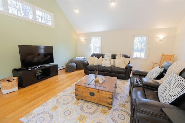 living area featuring wood finished floors, baseboard heating, and high vaulted ceiling