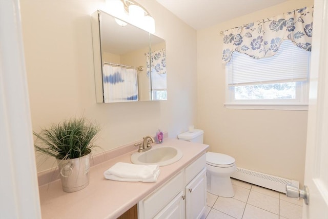 bathroom with tile patterned floors, toilet, vanity, and a baseboard radiator