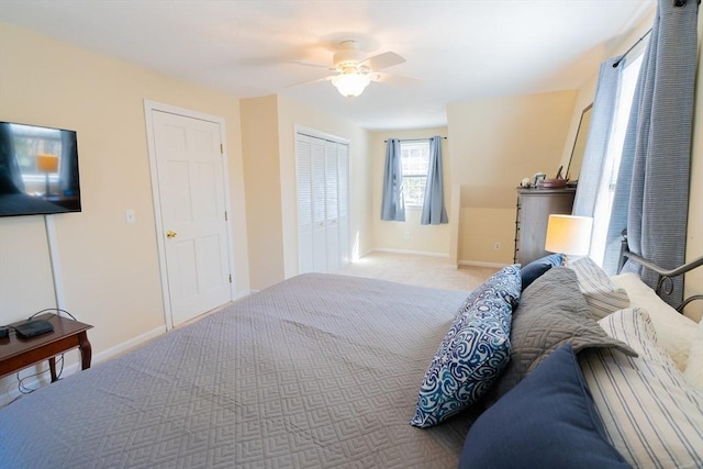 carpeted bedroom with baseboards, a closet, and ceiling fan