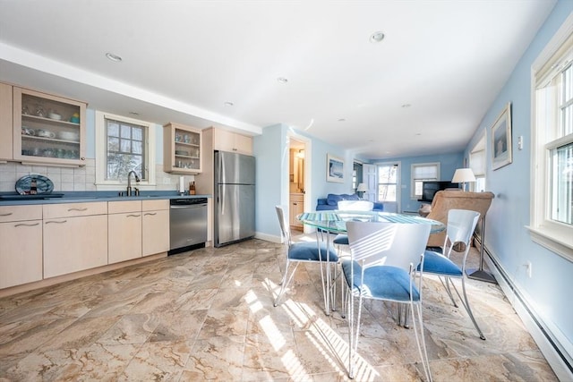 dining space with sink and baseboard heating