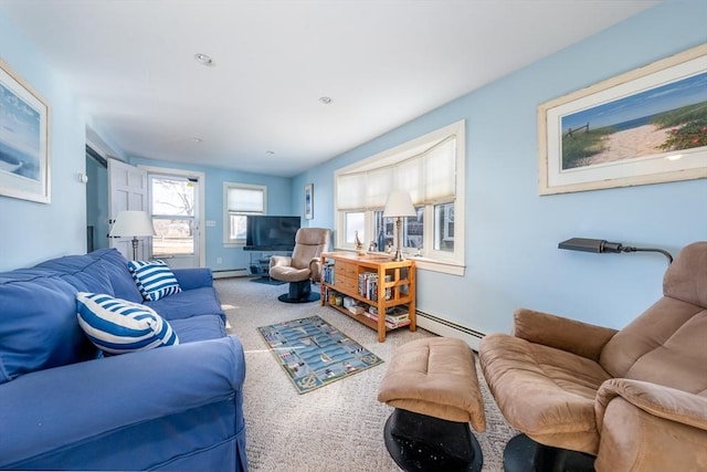 living room with baseboard heating and carpet