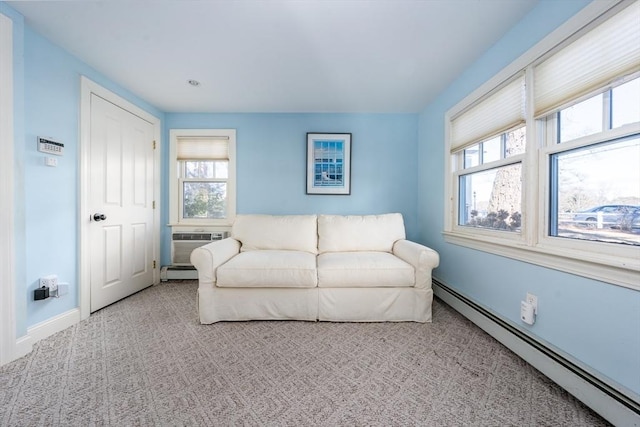 living room featuring a wall mounted AC, light carpet, and a baseboard heating unit