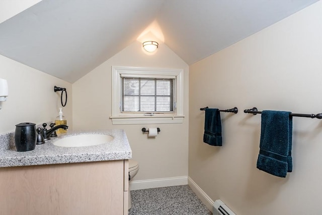 bathroom featuring vanity, vaulted ceiling, a baseboard radiator, and toilet