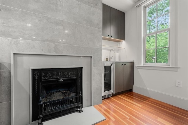 20 Birch Hill Rd, Newton, MA 02465 - detailed view of beverage cooler, wood finished floors, bar with sink, and a fireplace