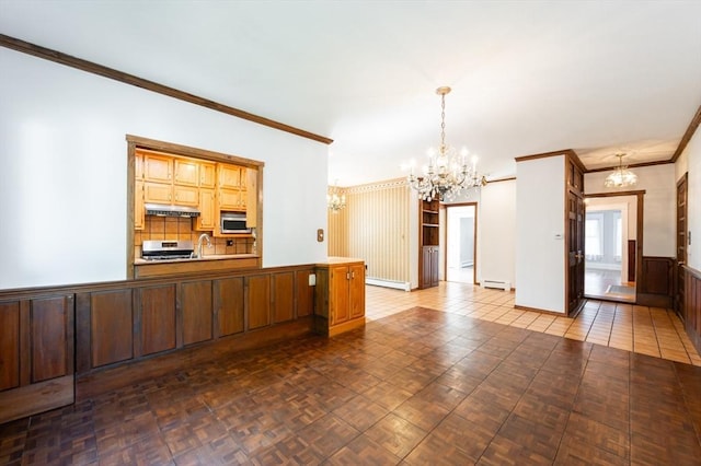 23 Shawmut Ave, Lowell, MA 01851 - kitchen featuring a chandelier, stainless steel microwave, ornamental molding, range, and a baseboard radiator