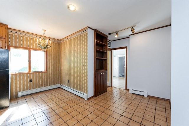 23 Shawmut Ave, Lowell, MA 01851 - empty room featuring a baseboard radiator, a chandelier, rail lighting, crown molding, and baseboards