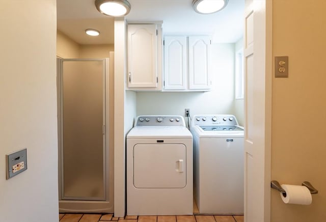 23 Shawmut Ave, Lowell, MA 01851 - laundry room featuring cabinet space, washer and dryer, and light tile patterned flooring