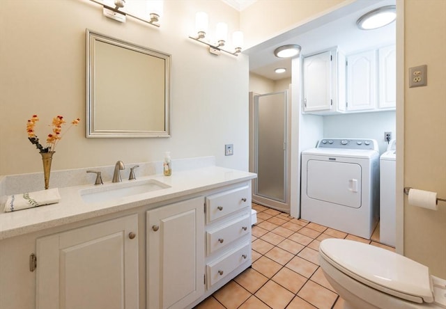 23 Shawmut Ave, Lowell, MA 01851 - bathroom with washer and dryer, a stall shower, vanity, toilet, and tile patterned flooring