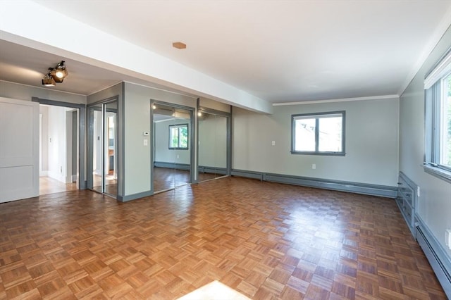 23 Shawmut Ave, Lowell, MA 01851 - unfurnished room with baseboard heating, baseboards, crown molding, and a baseboard radiator
