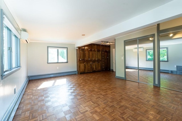 23 Shawmut Ave, Lowell, MA 01851 - unfurnished living room featuring a wall mounted AC, a baseboard heating unit, and baseboards
