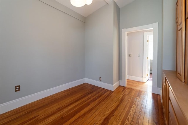 23 Shawmut Ave, Lowell, MA 01851 - unfurnished room with hardwood / wood-style flooring, baseboards, and vaulted ceiling