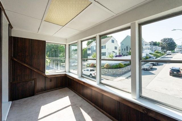 23 Shawmut Ave, Lowell, MA 01851 - unfurnished sunroom featuring carpet floors, wooden walls, and a residential view
