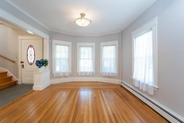 23 Shawmut Ave, Lowell, MA 01851 - foyer entrance with a baseboard radiator, plenty of natural light, stairway, light wood-style flooring, and ornamental molding