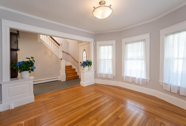 23 Shawmut Ave, Lowell, MA 01851 - entrance foyer with a baseboard radiator, stairway, wood finished floors, ornamental molding, and baseboards