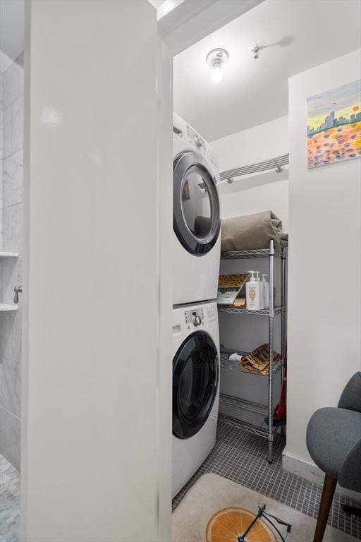 453 Washington St Unit 4A, Boston, MA 02111 - clothes washing area with laundry area, stacked washer and dryer, and tile patterned floors