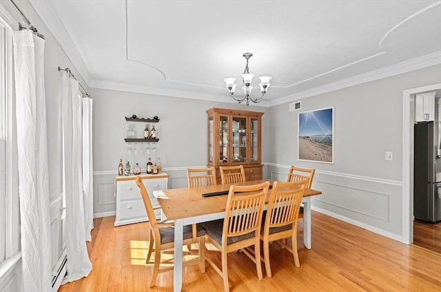 7 Paddock Way, Marshfield, MA 02050 - dining space with a chandelier, crown molding, light wood-style floors, plenty of natural light, and wainscoting
