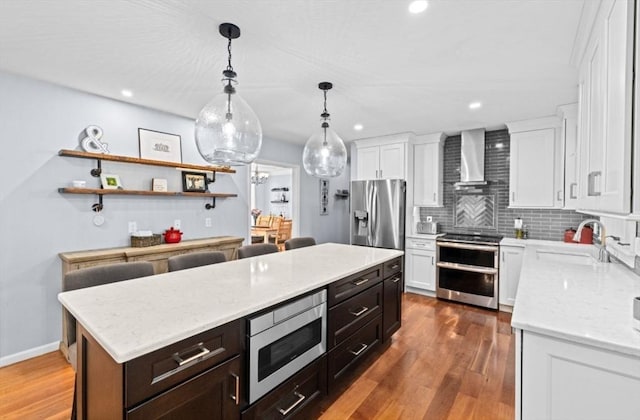 7 Paddock Way, Marshfield, MA 02050 - kitchen with stainless steel appliances, wall chimney range hood, white cabinets, backsplash, and a sink