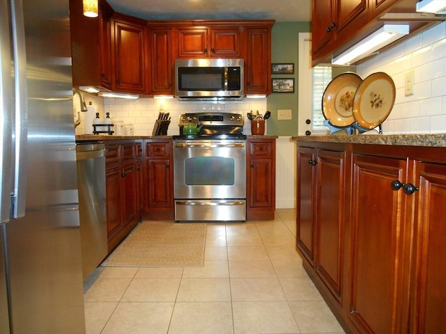 951 Dana Rd, Barre, MA 01005 - kitchen featuring stainless steel appliances, tasteful backsplash, dark brown cabinets, light tile patterned flooring, and stone counters