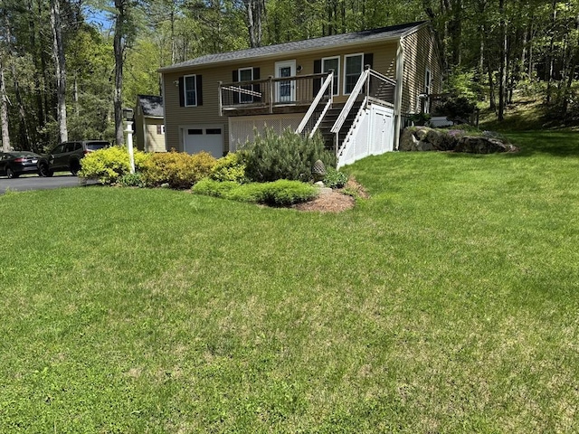 951 Dana Rd, Barre, MA 01005 - view of front of property featuring an attached garage, a front lawn, a wooden deck, stairway, and asphalt driveway