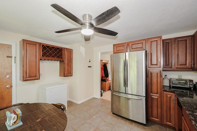 3 Myles Standish Dr Unit 8, Haverhill, MA 01835 - kitchen with freestanding refrigerator, ceiling fan, dark stone counters, light tile patterned floors, and refrigerator