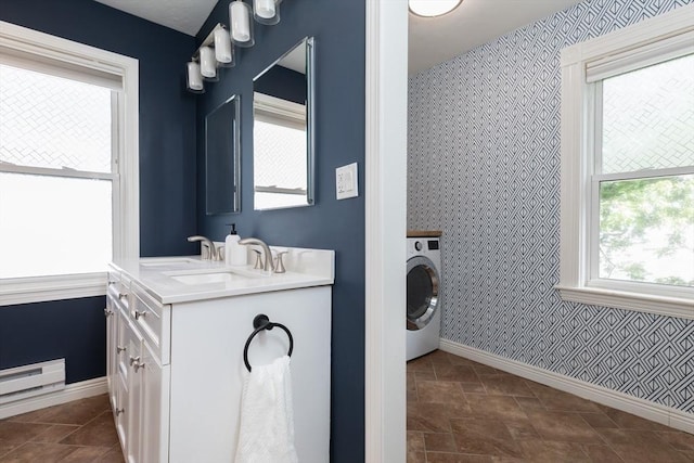 27 Round Hill St, Boston, MA 02130 - bathroom with washer / clothes dryer, wallpapered walls, double vanity, stone finish flooring, and a baseboard heating unit
