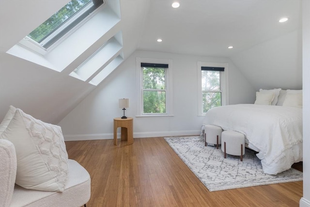 27 Round Hill St, Boston, MA 02130 - bedroom with a skylight, vaulted ceiling, wood finished floors, and recessed lighting