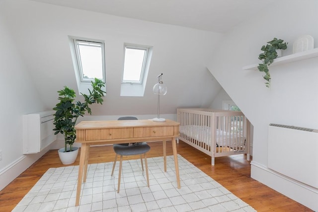 27 Round Hill St, Boston, MA 02130 - bedroom featuring an office area, light wood-style floors, and radiator