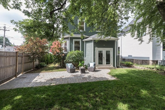 27 Round Hill St, Boston, MA 02130 - rear view of property with french doors, a fenced backyard, and a patio area