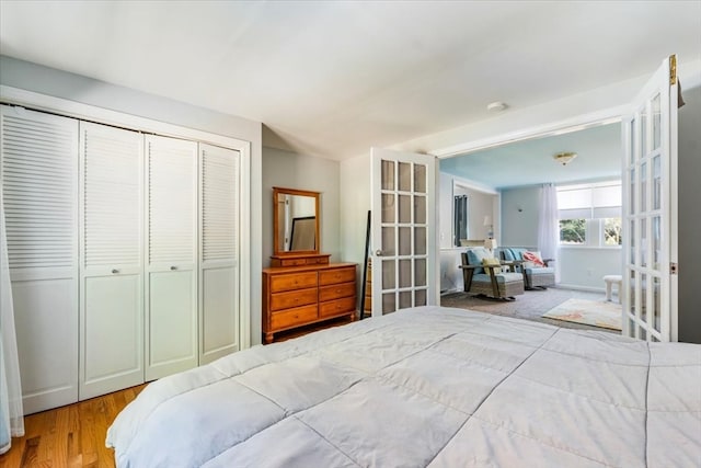 bedroom featuring french doors, hardwood / wood-style flooring, and a closet