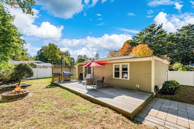 back of property featuring a deck and a yard