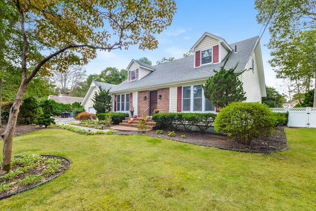 new england style home featuring a front lawn