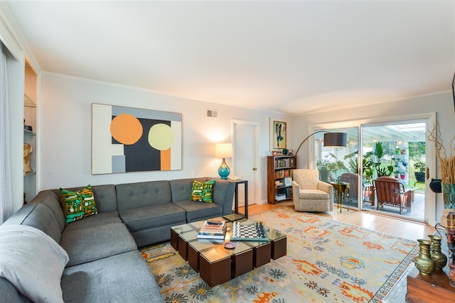 living room featuring hardwood / wood-style floors and crown molding