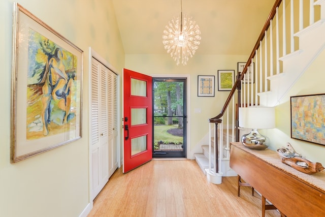 entryway with an inviting chandelier and light wood-type flooring